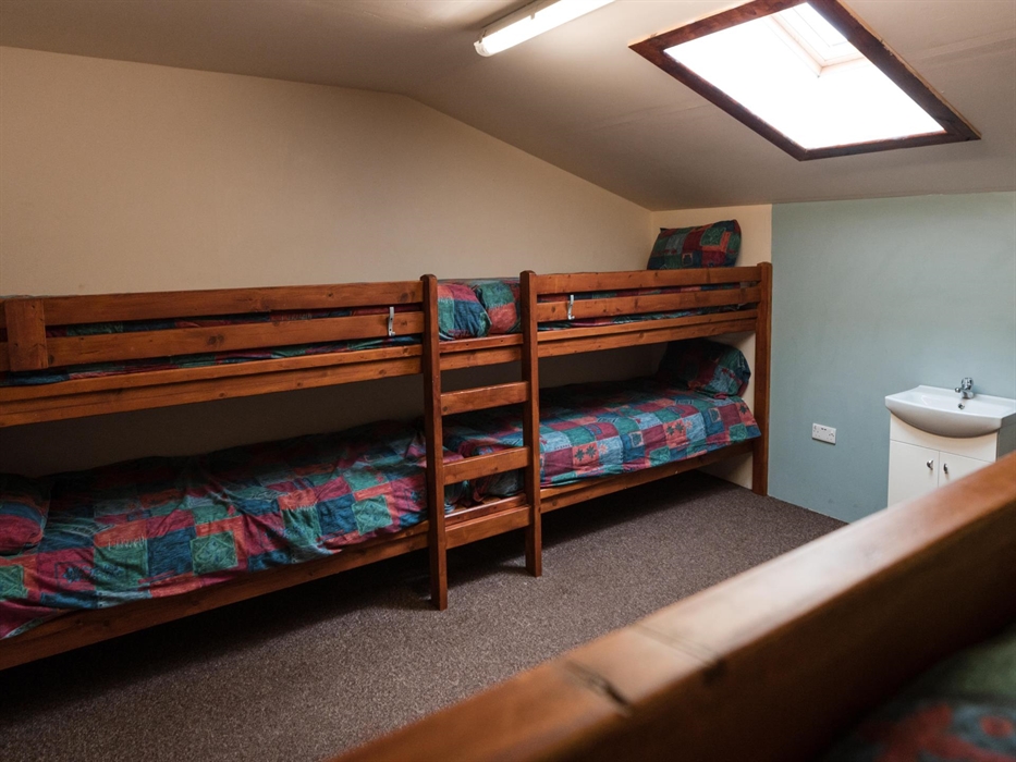 The larger accommodation has 18 rooms spread over two floors, with Velux windows fitted for fresh air ventilation and a sink in the upstairs room. The