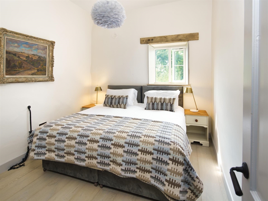Bron Y Felin sleeps 6 in three bedrooms - this super king bed can be split into twin beds. The brand new bed has a welsh blanket, the window has shutt