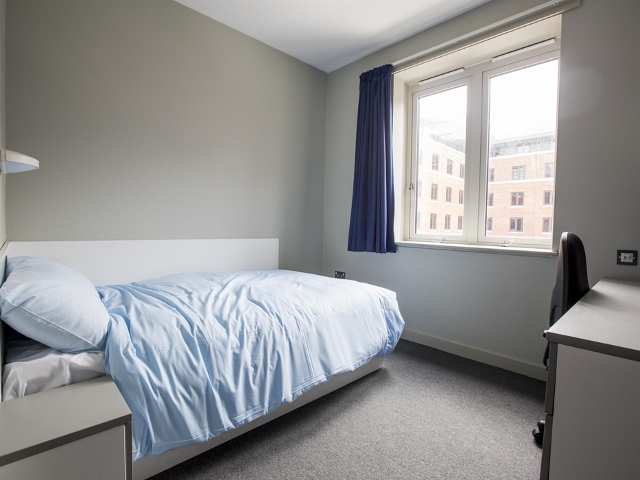 bedroom with a bed, desk with chair