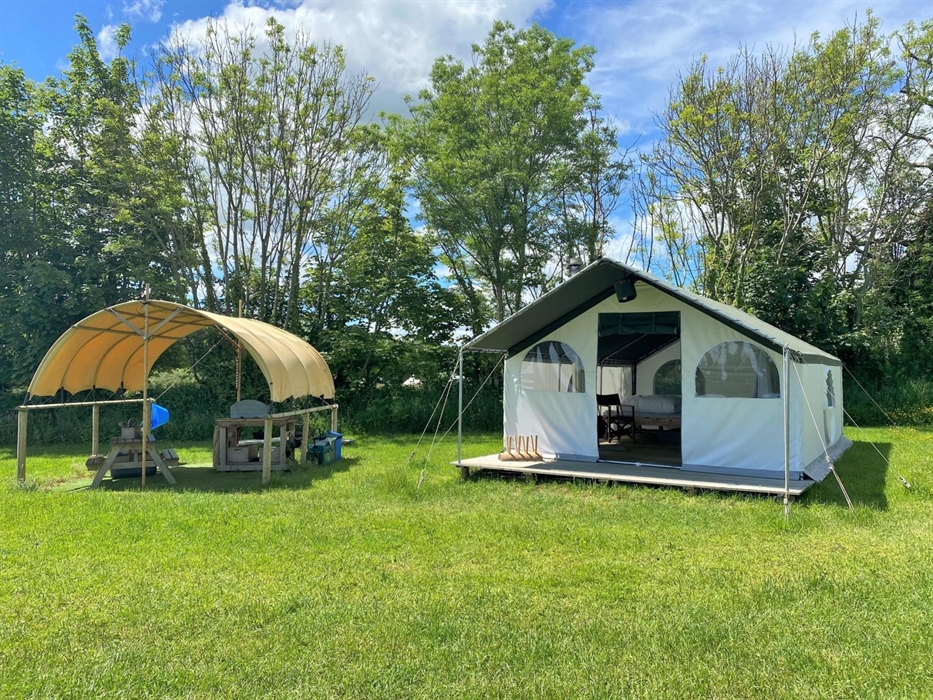 Pioneer Glamping tents come with their own covered kitchen positioned around the wildflower meadow with plenty of space for games and hanging out side