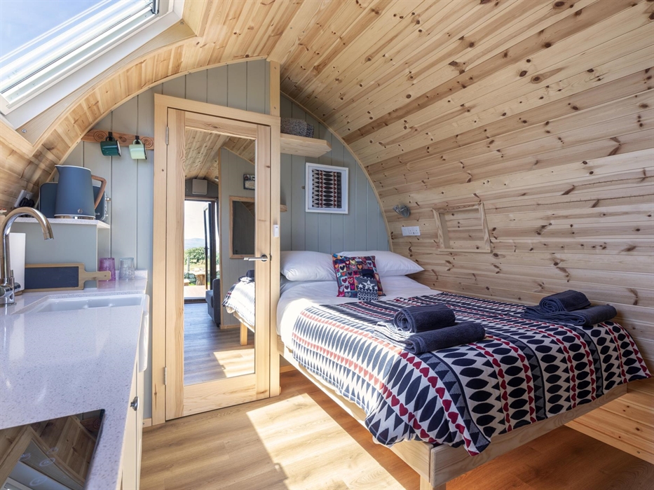 Luxury Glamping Pod. Nicely decorated with Welsh blankets, Hot water bottle and Calon Lan Cushion. Kitchenette area with Oven/microwave, Toaster and K