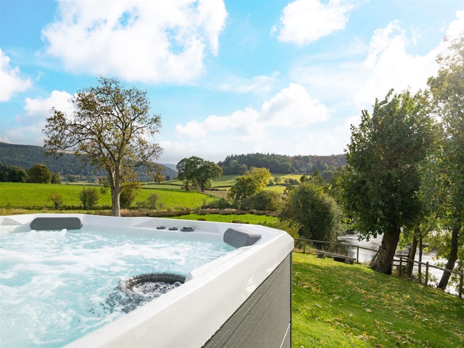 Not only do you have your private luxury hot tub but look at the views that come with it! The rolling hillside of the Welsh countryside is enough to t