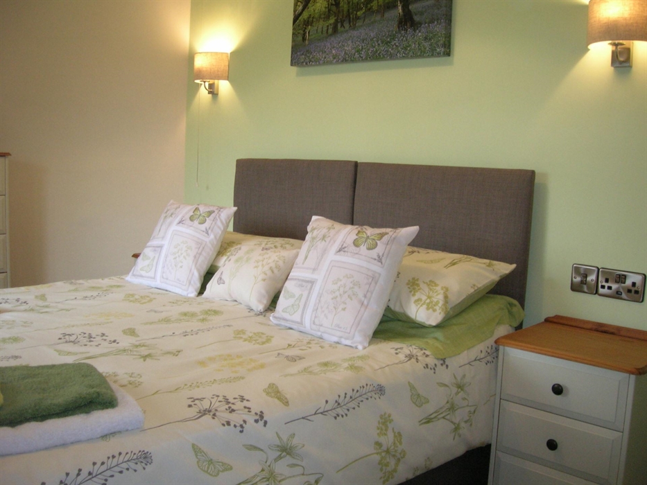 The second bedroom is at the back of the house and has a comfy King zip and link bed. It overlooks the fields of nearby Bryncoch Farm.