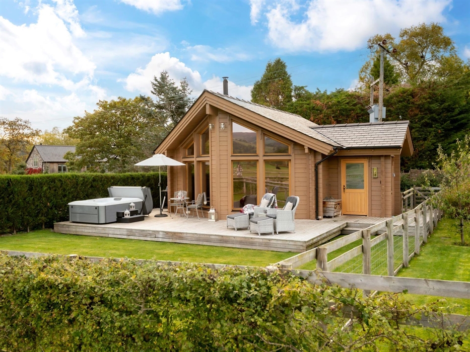 A private decking area with an enclosed garden .
