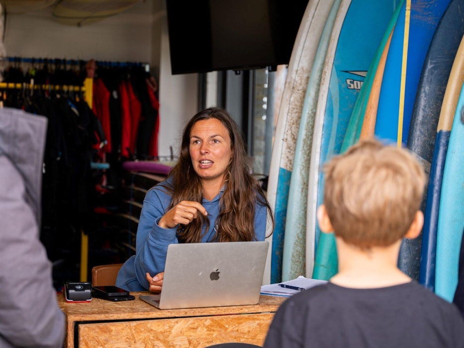 Image of staff member talking to customers at reception