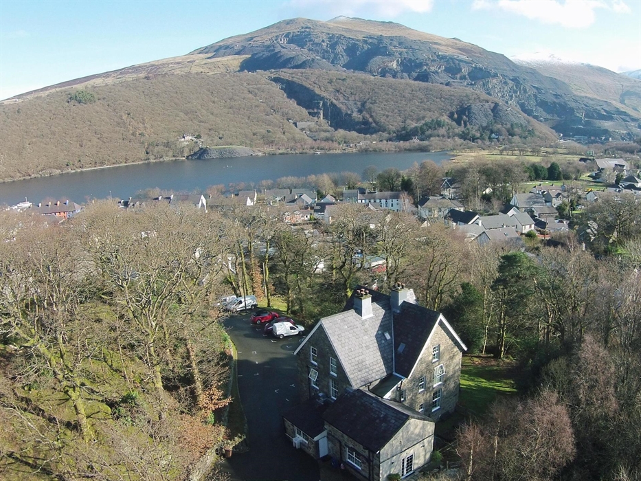 Bryn Du Mountain Centre drone photo, car park, woodland, Llanberis Village, Llyn Padarn Lake, Slate Quarry and Mountain View