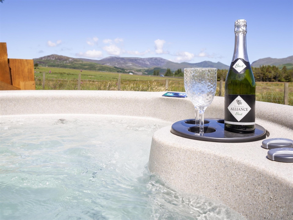 Hot Tub with panoramic views of the Snowdonia Mountains and Cambrian Coast.  Glamping Pod is situated near Criccieth, on a Welsh working farm.