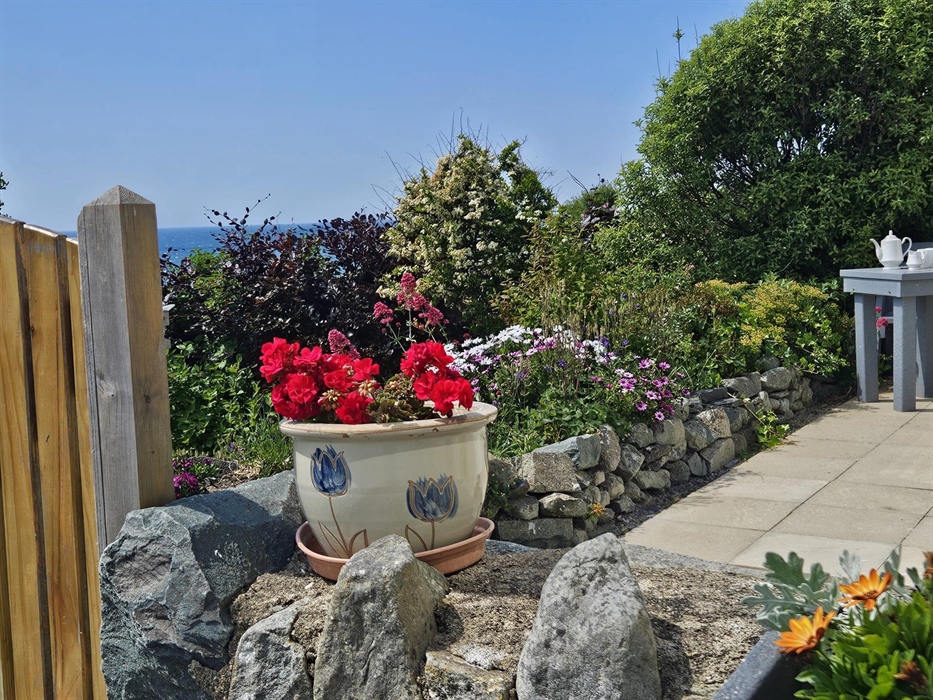 Sit outside in peaceful surroundings and look out over the beautiful bee friendly garden and the Cardigan Bay coastline.
