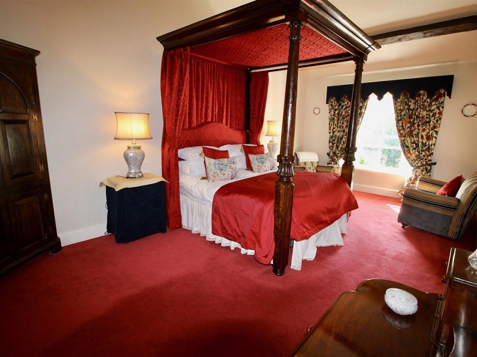 Original 4 poster bed, large ensuite and dressing area.  Sofa and chairs.  Feature fireplace