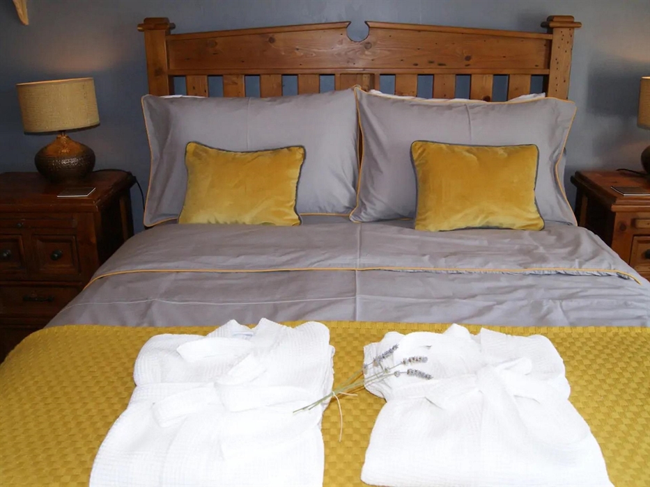 The bedroom has a kingsize bed, a wardrobe, chest, bedside chests with lamps. A hairdryer is supplied.