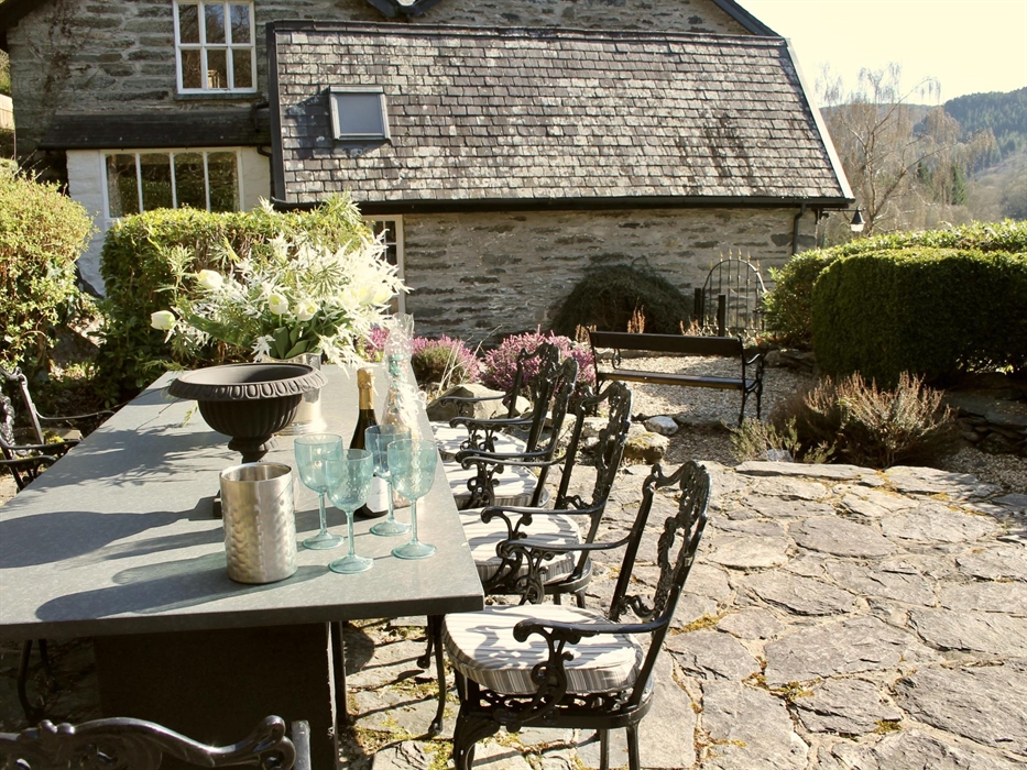 Double doors from the kitchen leading to landscaped gardens which is private and hedging all around.