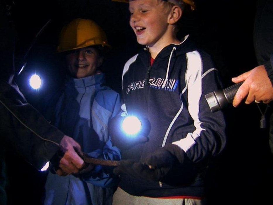Girl and Boy visiting an old Welsh Slate Mine with Corris Mine Explorers in Mid Wales
