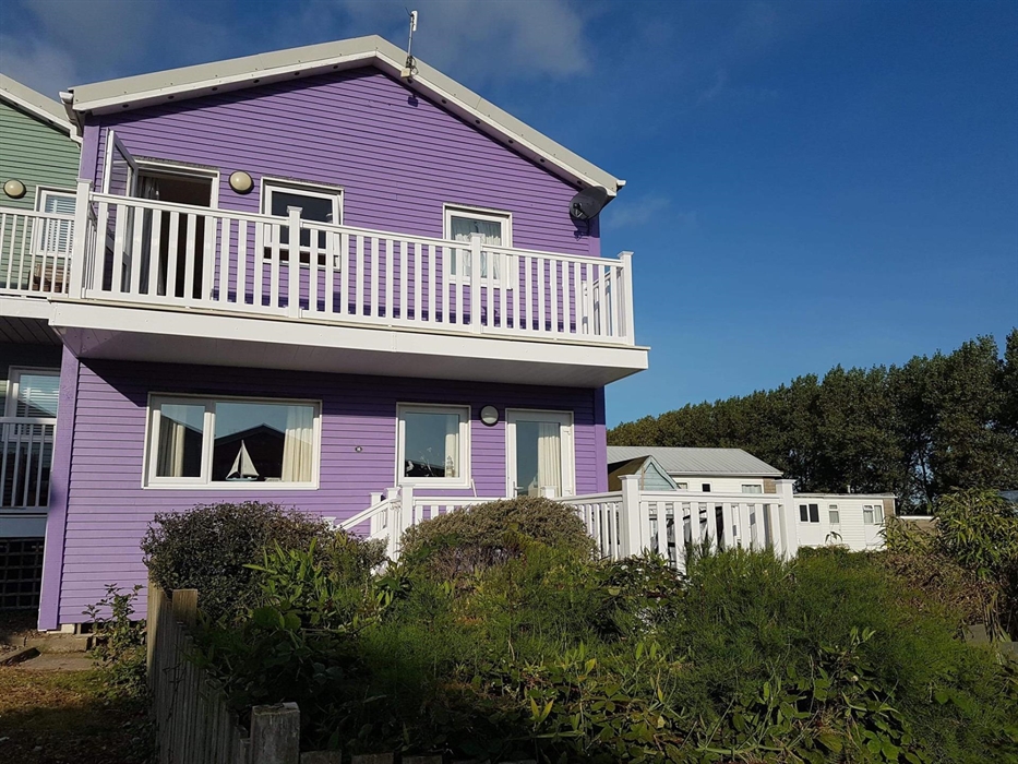 Freshwater East Pembrokeshire holiday let, beach views, sleeps six, dogs welcome, child friendly.  A lavender painted, beach house, sitting in a wrap