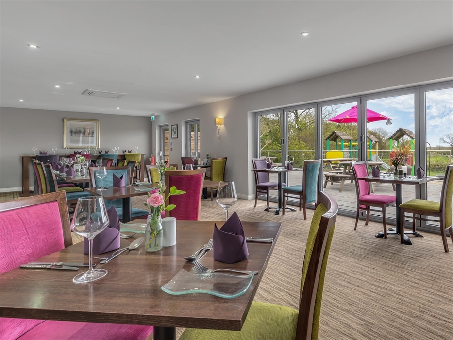 With view of children's play area and outdoor terrace.