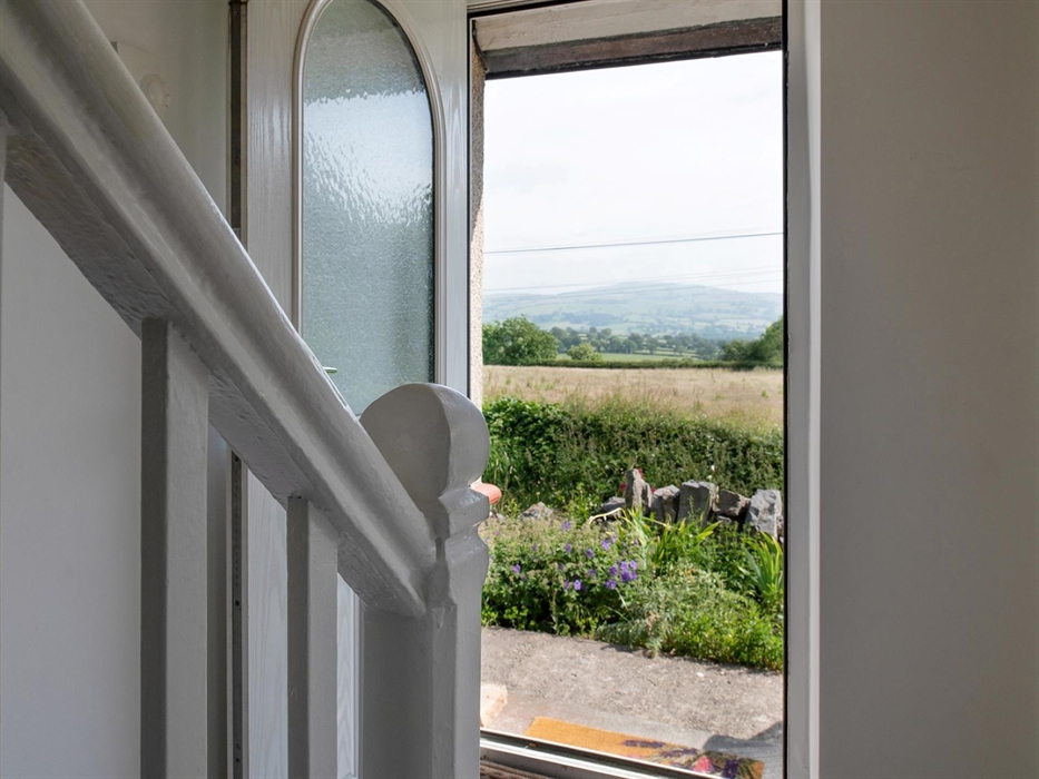 As you step out of the front door you are immediately in the countryside. To your right, you will find a bistro table and two chairs, lovely for a bit