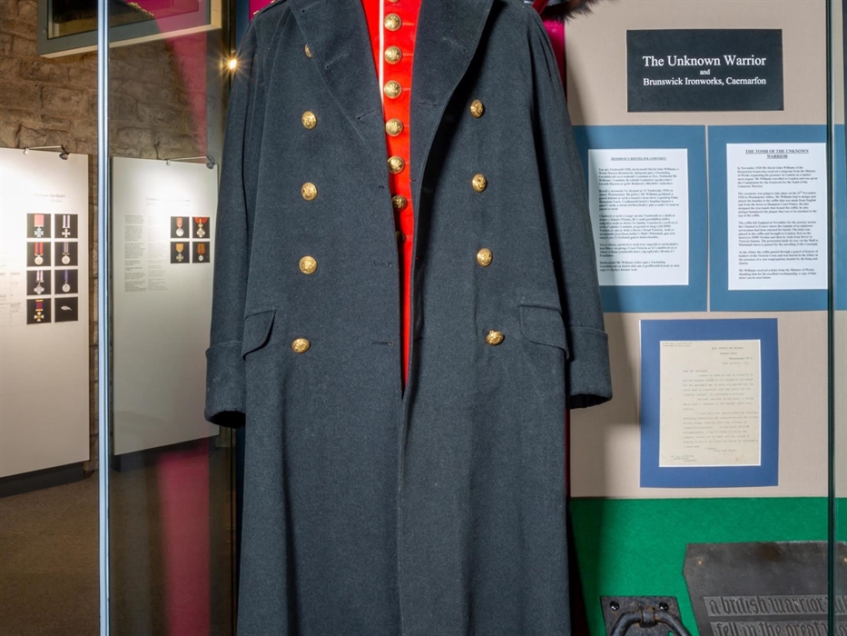 The RWF Greatcoat worn by King George V, alongside the prototype ironwork for the coffin of "The Unknown Soldier." Produced at Caernarfon by the Bruns