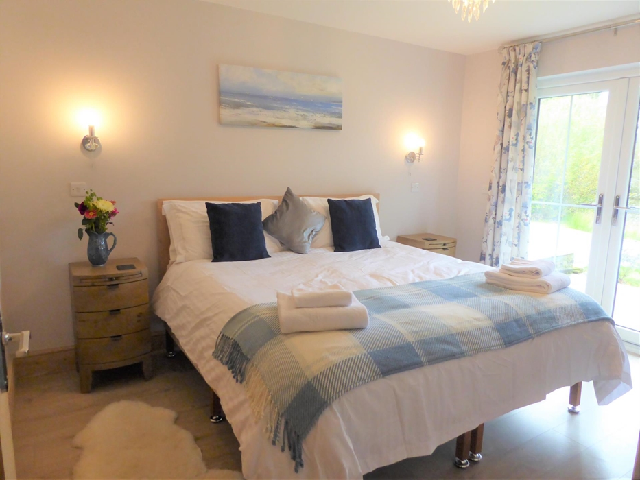 Bedroom 3 (ground floor) with superking size bed or 2x single beds and a smart TV.  Adjoining is an ensuite room with walk in shower.  This bedroom ha