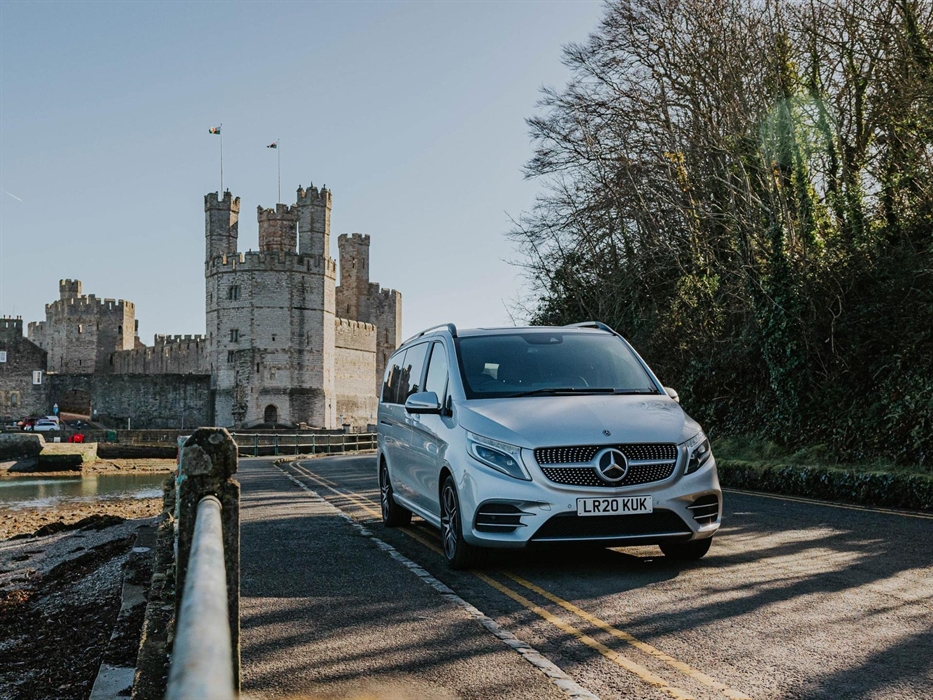 Celticos' Executive Touring vehicle beside Caernarfon Castle