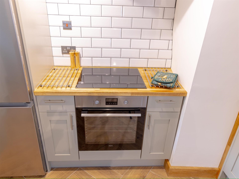Fully equipped kitchen with dishwasher, fridge freezer induction hob and oven with grill.