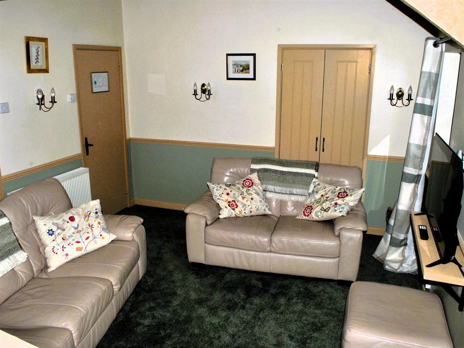 The lounge is newly furnished and carpeted with Smart TV. The twin bedroom leads off from it in one direction and the front door and kitchen the other