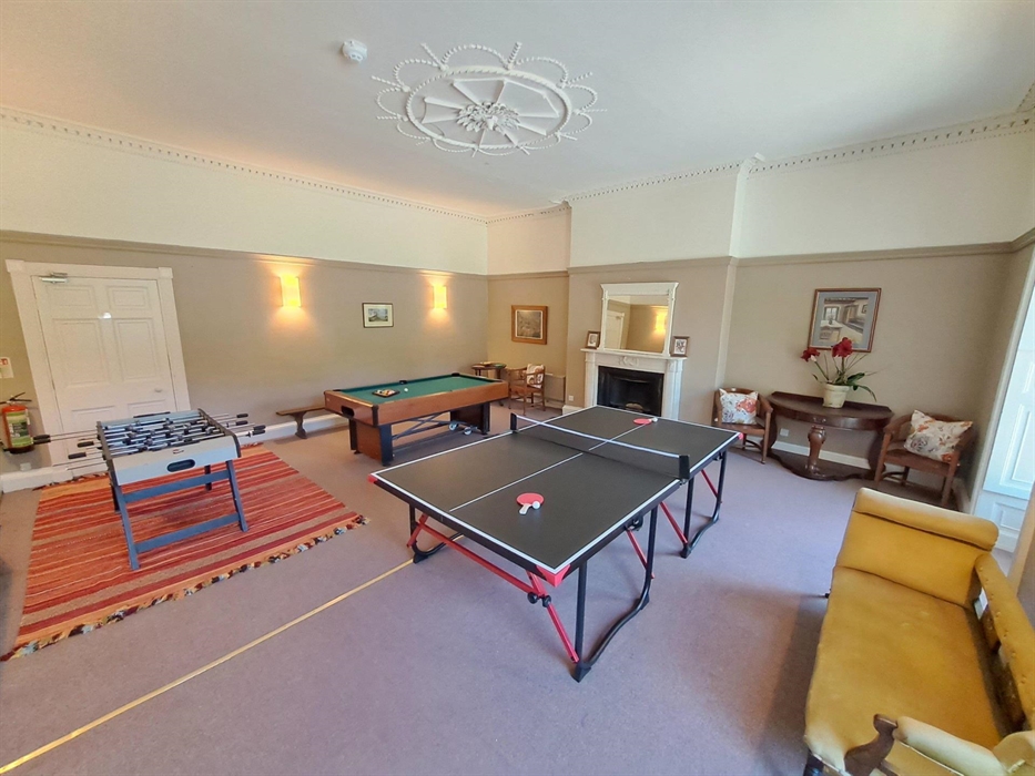 This large ground floor room is shown set up, ready for a family and friends gathering to have some fun. The games tables can all be put for conferenc