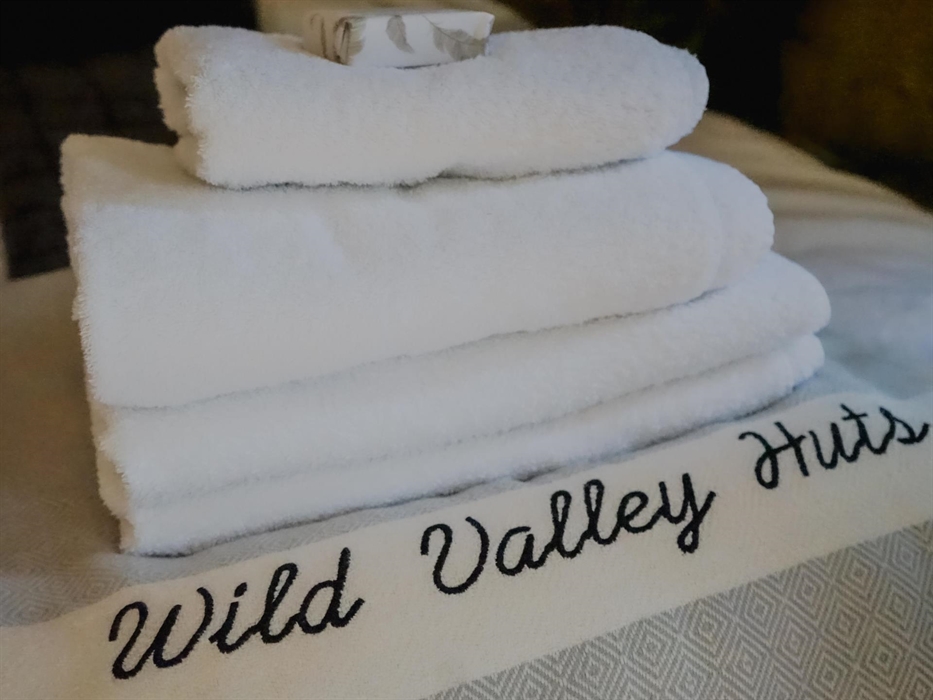 We provide fresh bedlinen and towels (hand & bath) for guest's arrival.  
Robes are provided for guests to use with the hot tub or for relaxing in the