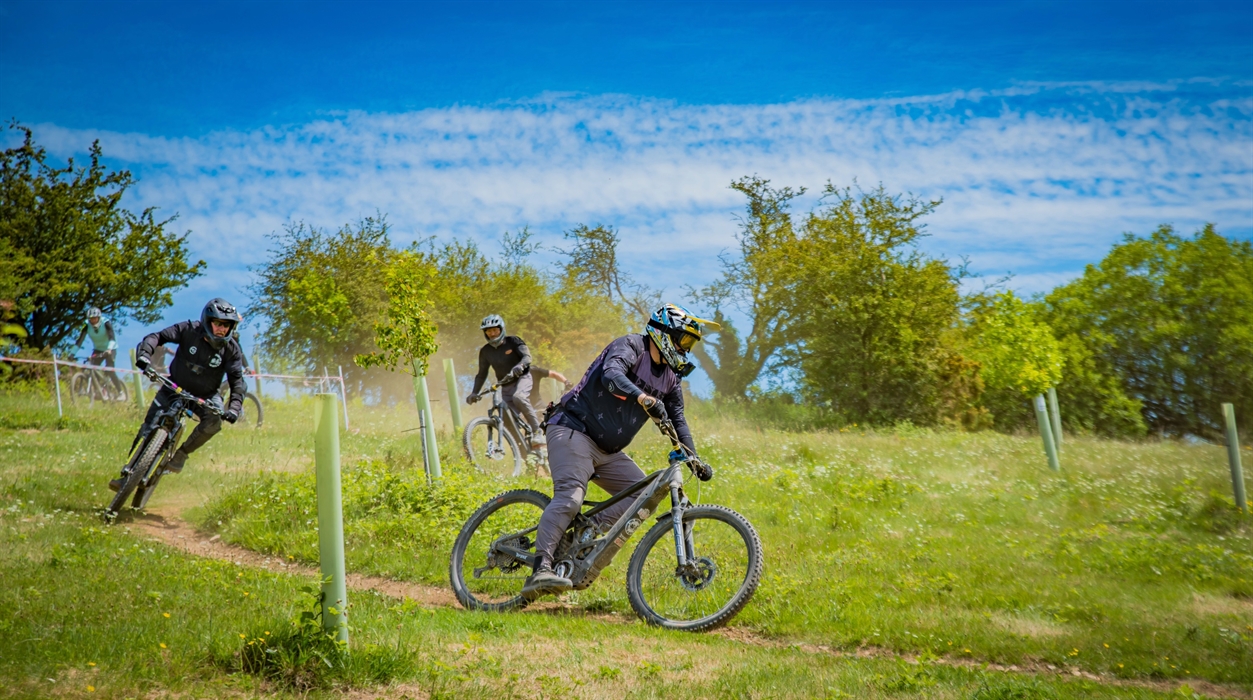 A group of riders enjoying dusty trail conditions.