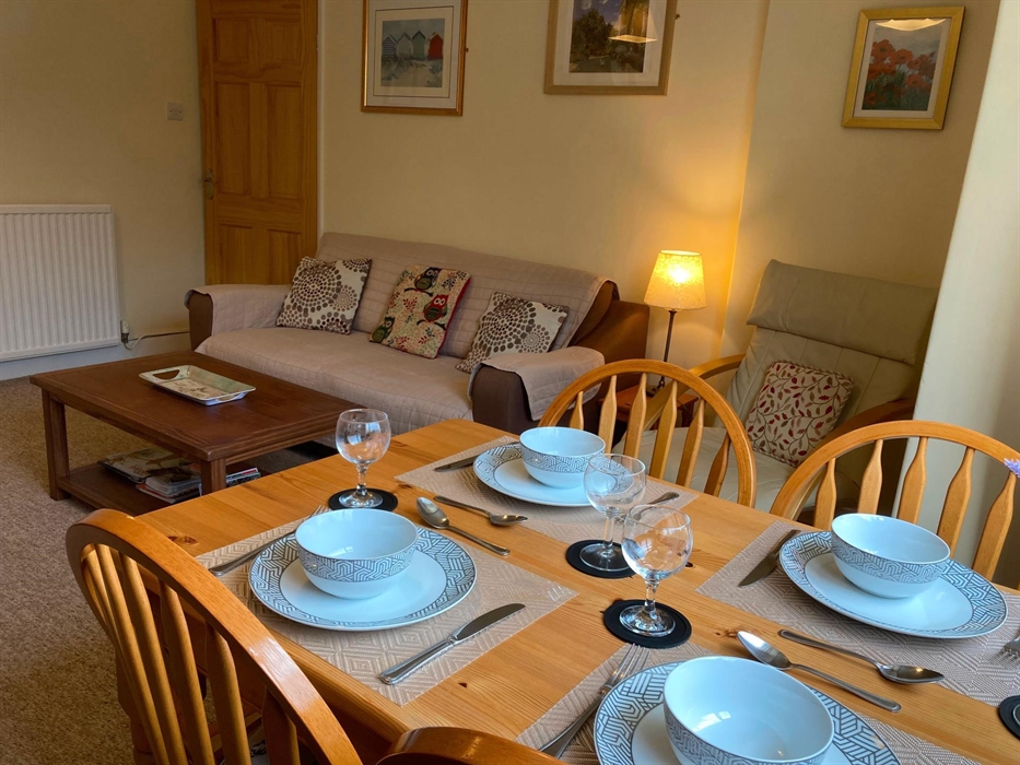 Comfy lounge and dining room. Dining table with view of the mountains