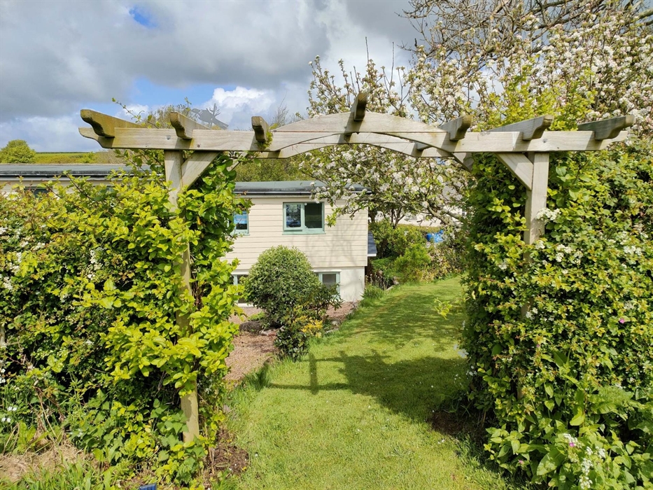 Back of the cottage through one arbour