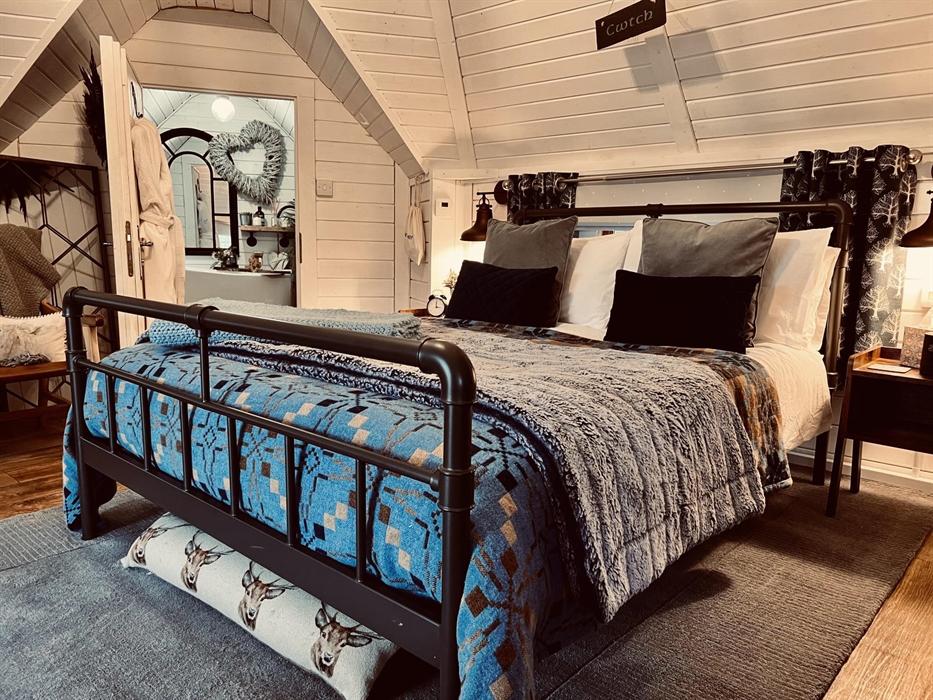 Our comfortable double bed is located in the centre of the cabin and always laden with cosy, cwtchy blankets! Just open your door for unbroken views o