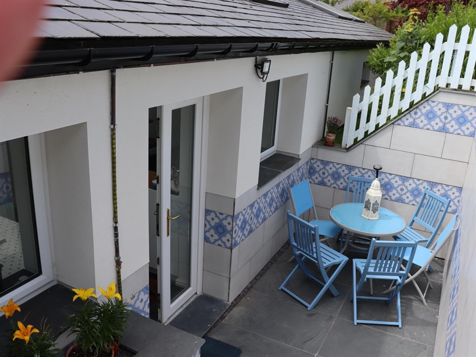 Steps up to secure garden, more gentle steps on other side of Cottage. Back Door leads into Kitchen/Diner from parking area. Lighting for the evening.