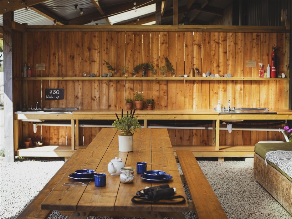 A covered outdoor dining and living space.