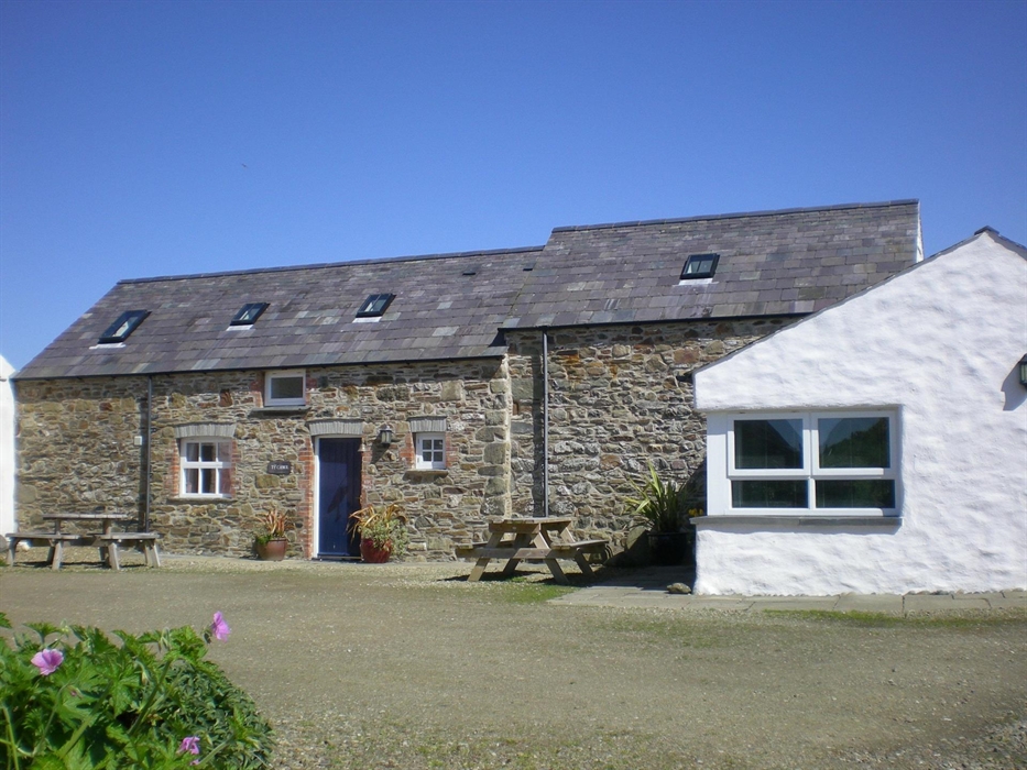 Stone walls and slate roofs of the cottages look towards the sea. This area is called the Haggard, named after the place where the hay was stored as a