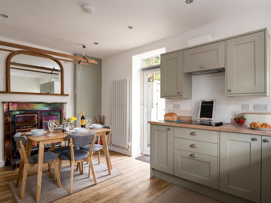 The kitchen is large and spacious, the table will seat 6 but can also be extended for extra space.  There is an antique range with an open fire.  The