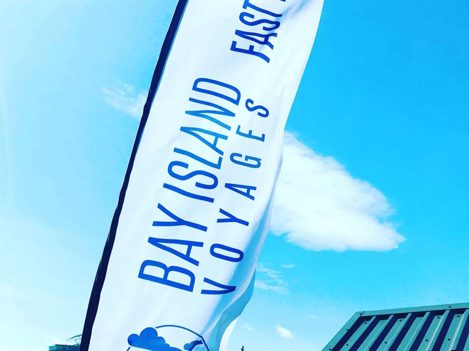 Bay Island Voyages flag flying in the wind