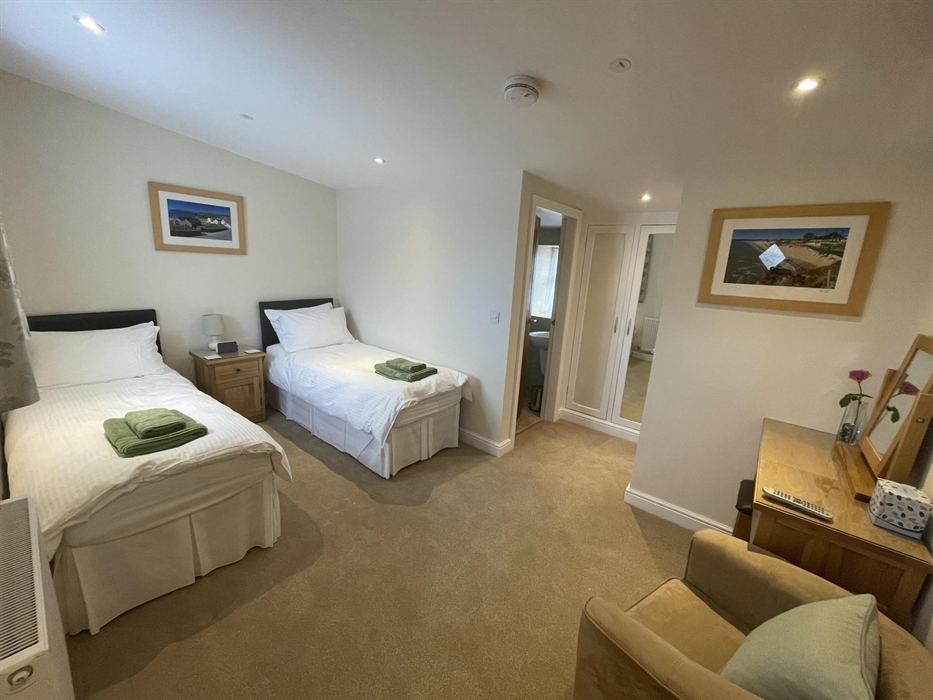 second bedroom shown a twin room with two 2'6" single beds & en-suite shower room