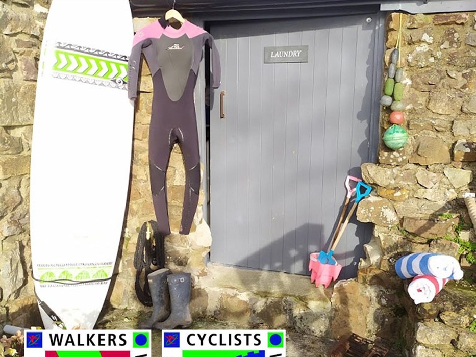 Communal laundry with storage and hanging space.