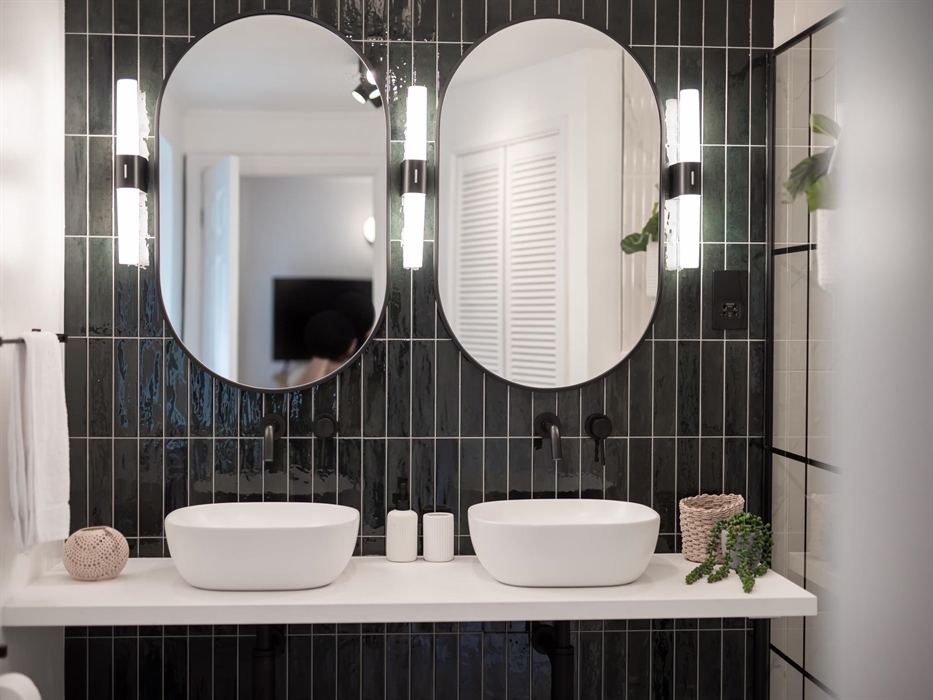 The his-and-hers sinks offer a personal space for both, making morning routines seamless and harmonious.