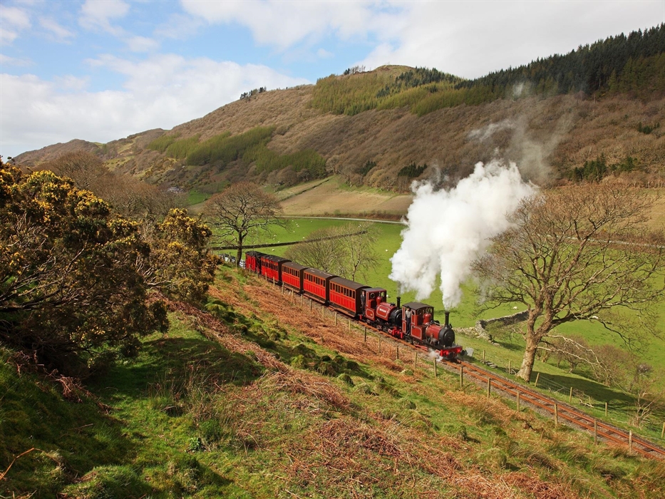 The two original loco's 'Talyllyn' and 'Dolgoch' dating from 1865 and 1866, pull the original carriages up the valley towards Abergynolwyn.  Pic Ralph