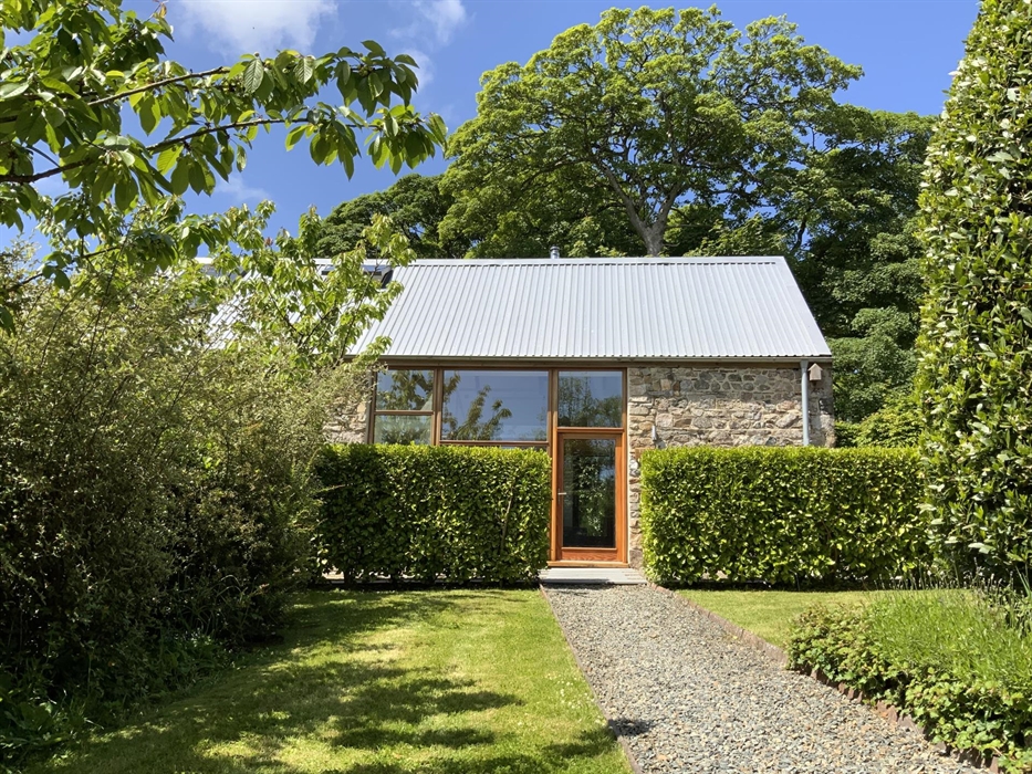 Looking across front garden to the barn from the parking area