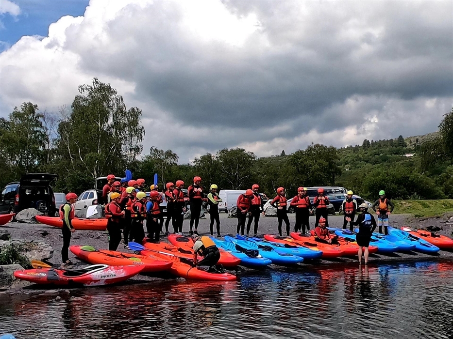 Large group of adults about to go kayaking on Llyn Padarn