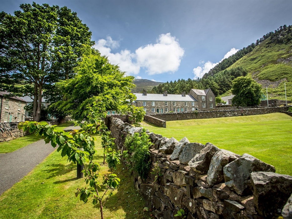 Stone quarryman's cottages against a mountainous backdrop