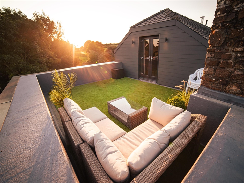Ascend to the roof terrace, where comfortable sun loungers await, offering a sublime spot for sunbathing or stargazing as dusk settles.