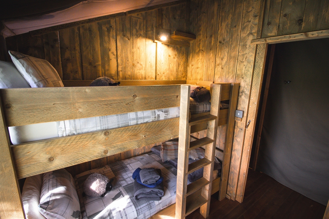 Bunk bedroom with cosy bedding and blankets to keep warm.
