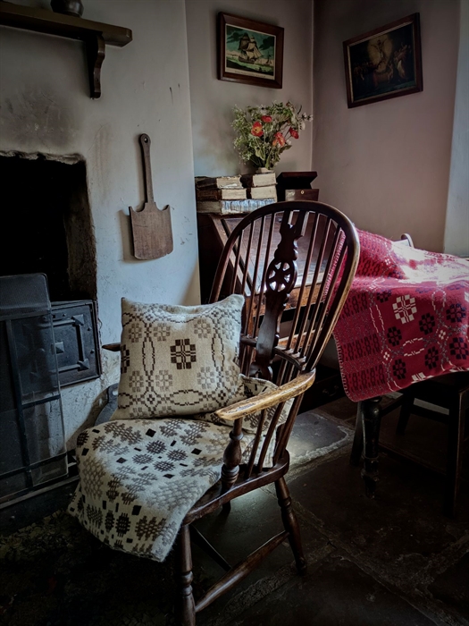 Woven blankets and cushions on a rocking chair