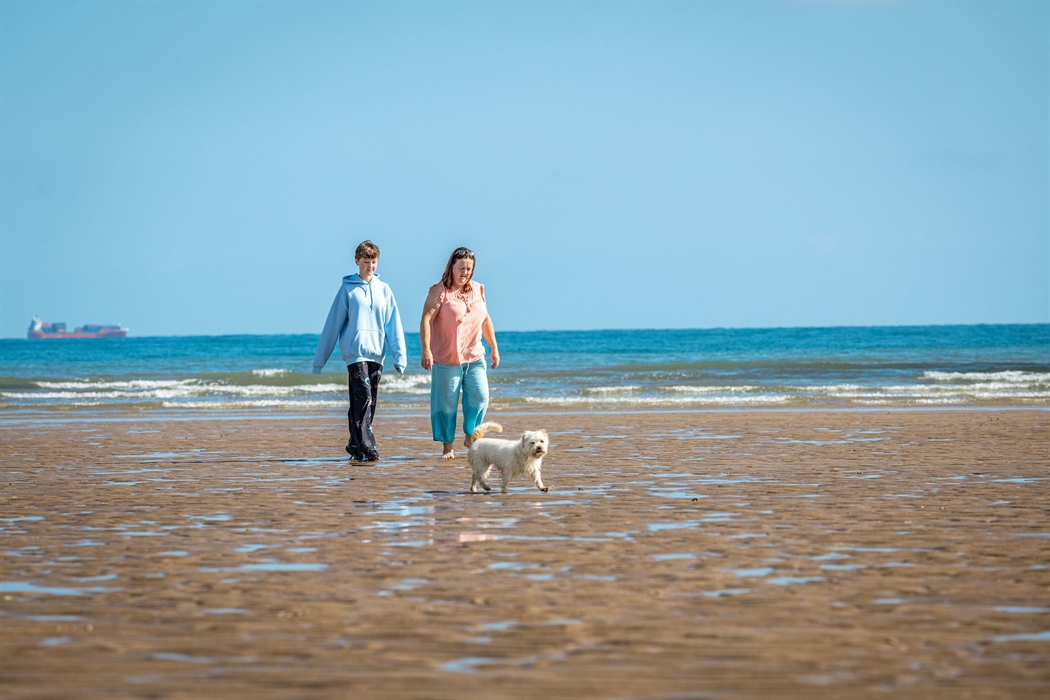 Lligwy beach with couple and dog
