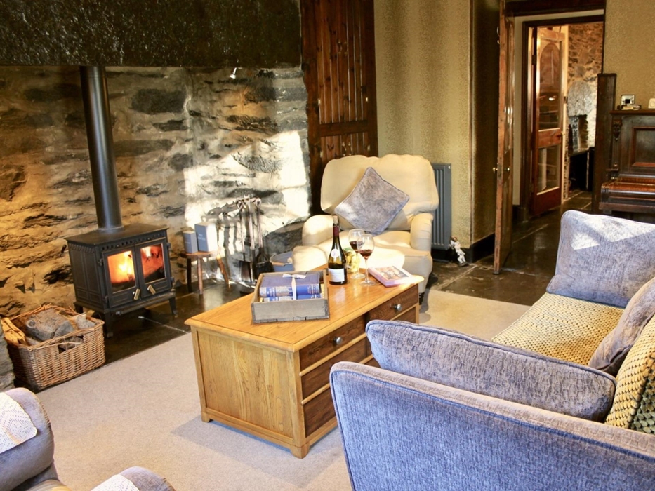 Lounge with large french door onto patio, large original window facing the lawned garden, woodturner, tv with dvd player.