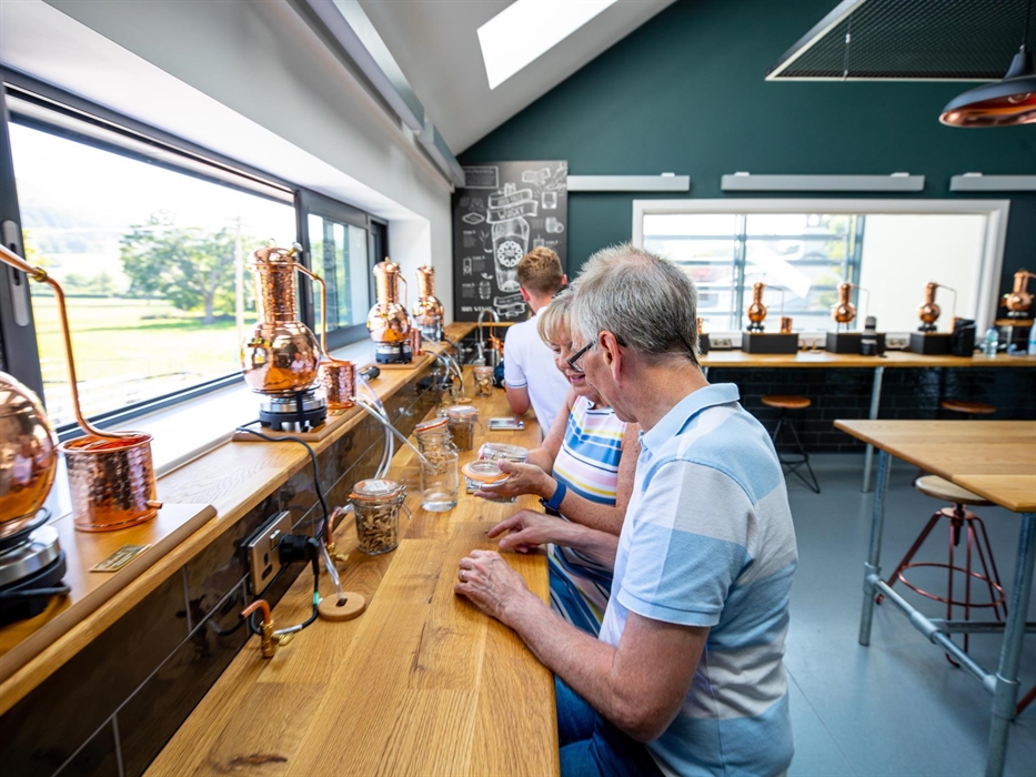 Interior if the Gin Lab at Aber Falls, showing 3 people making gin