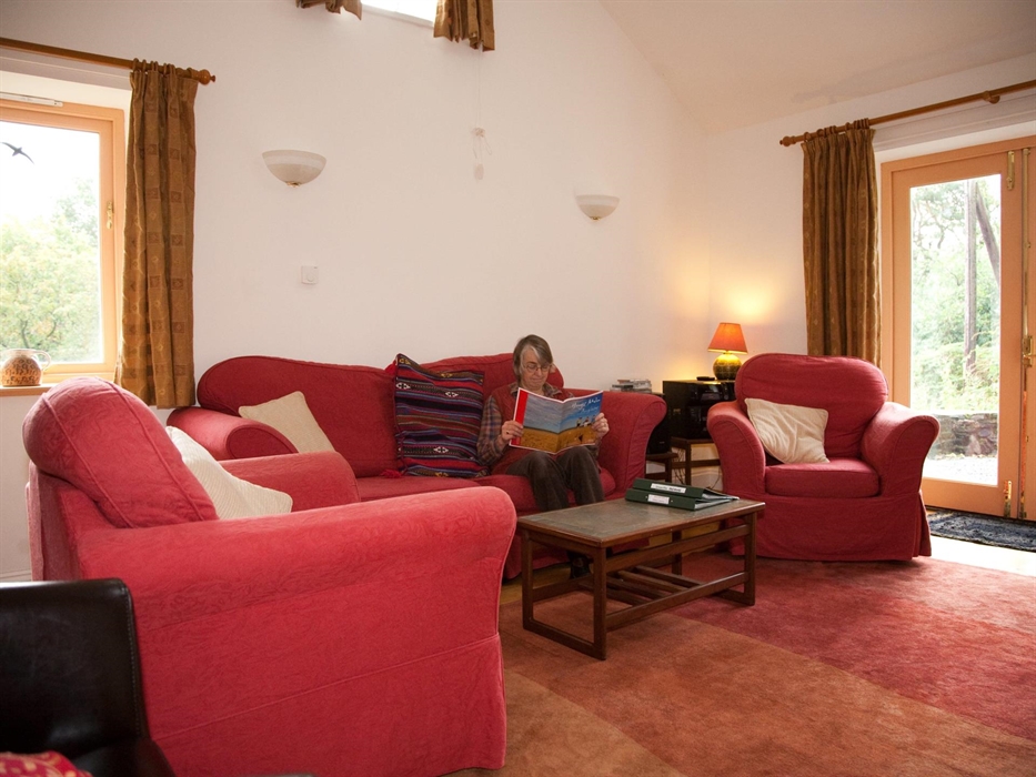 Sitting room with windows to the west and south. TV and DVD, radio, mobile wifi, books and games, woodburner and logs