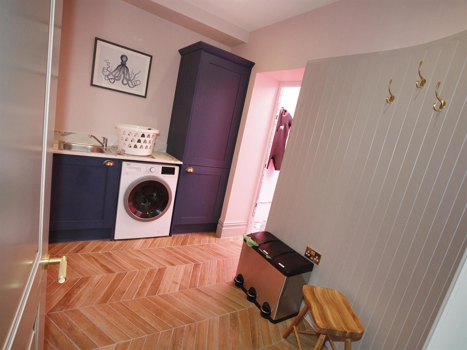 situated on the ground floor, washer dryer, sink, access to rear.